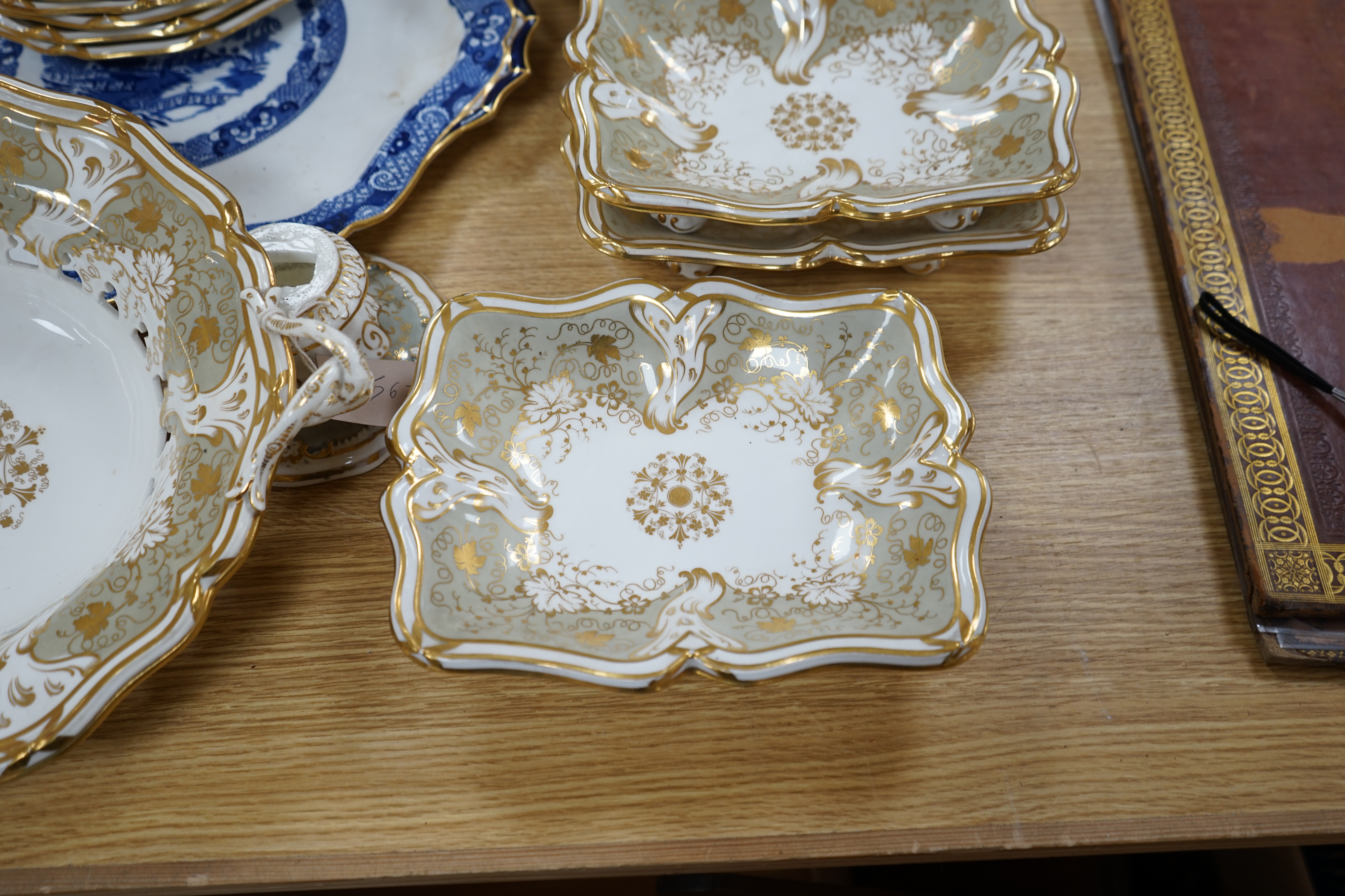 A Davenport part grey and gilt dessert service, together with a blue and white circular serving dish, dish 43cm wide. Condition - comport base broken